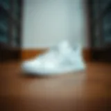 Stylish White Adidas Sneakers Stylish white Adidas sneakers on a wooden floor