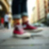 A stylish pair of Converse All Star bordo sneakers on a city street