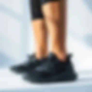Stylish display of Under Armour black shoes against a minimalist backdrop